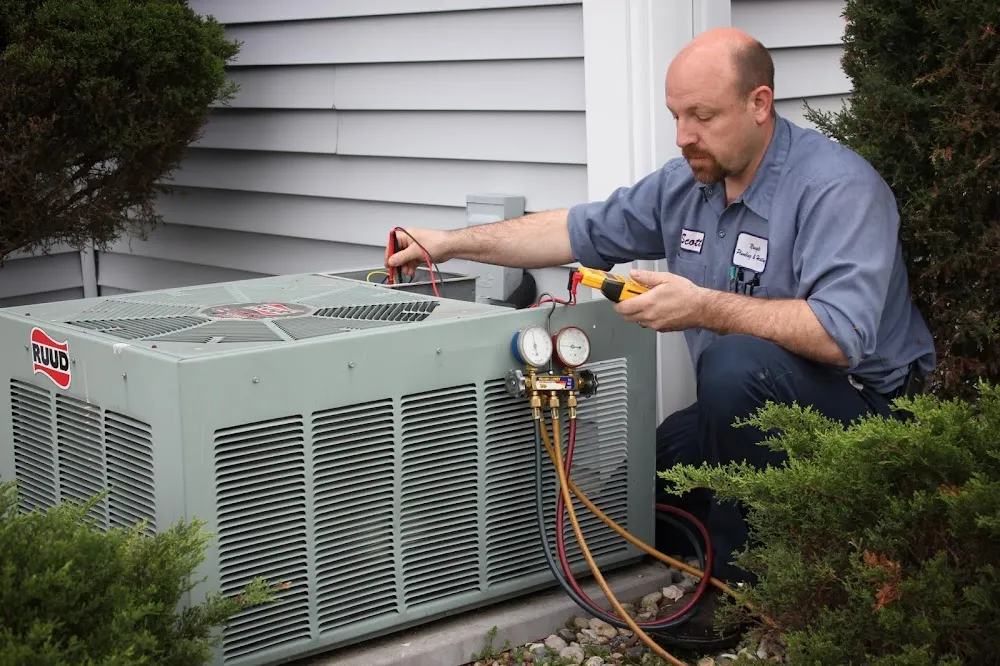 Naugle technician servicing a residential central air condenser