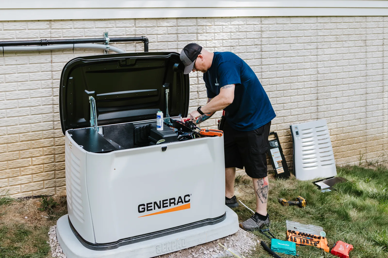 Naugle electrician working on a Generac standby generator