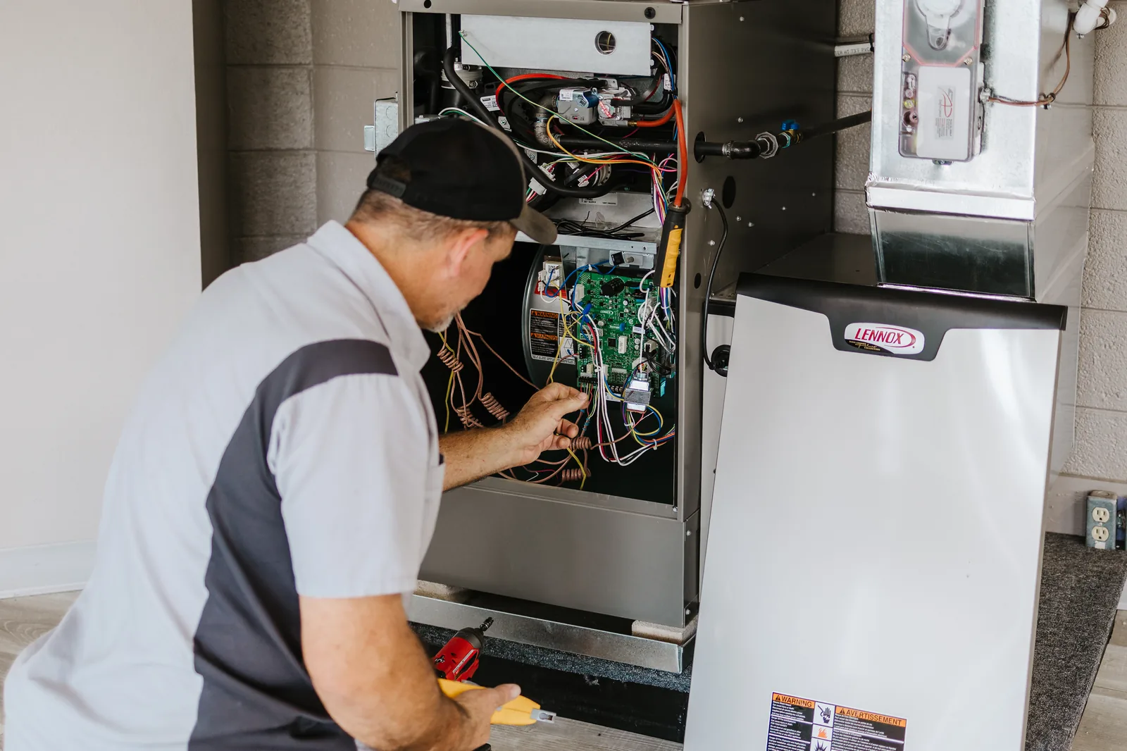 Naugle heating technician diagnosing a Lennox furnace