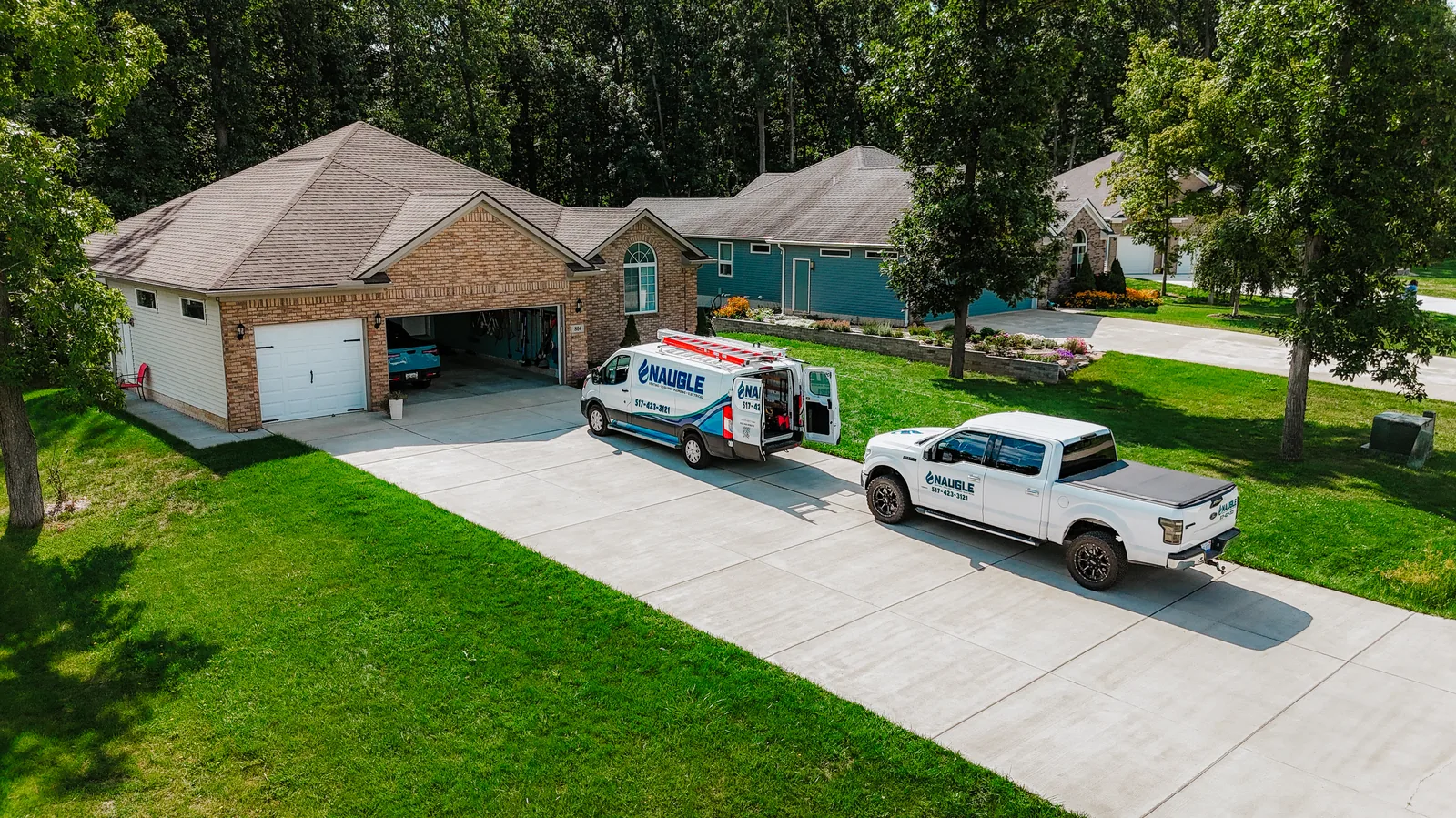 Aerial view of the Naugle service fleet at the Tecumseh shop on S Adrian St